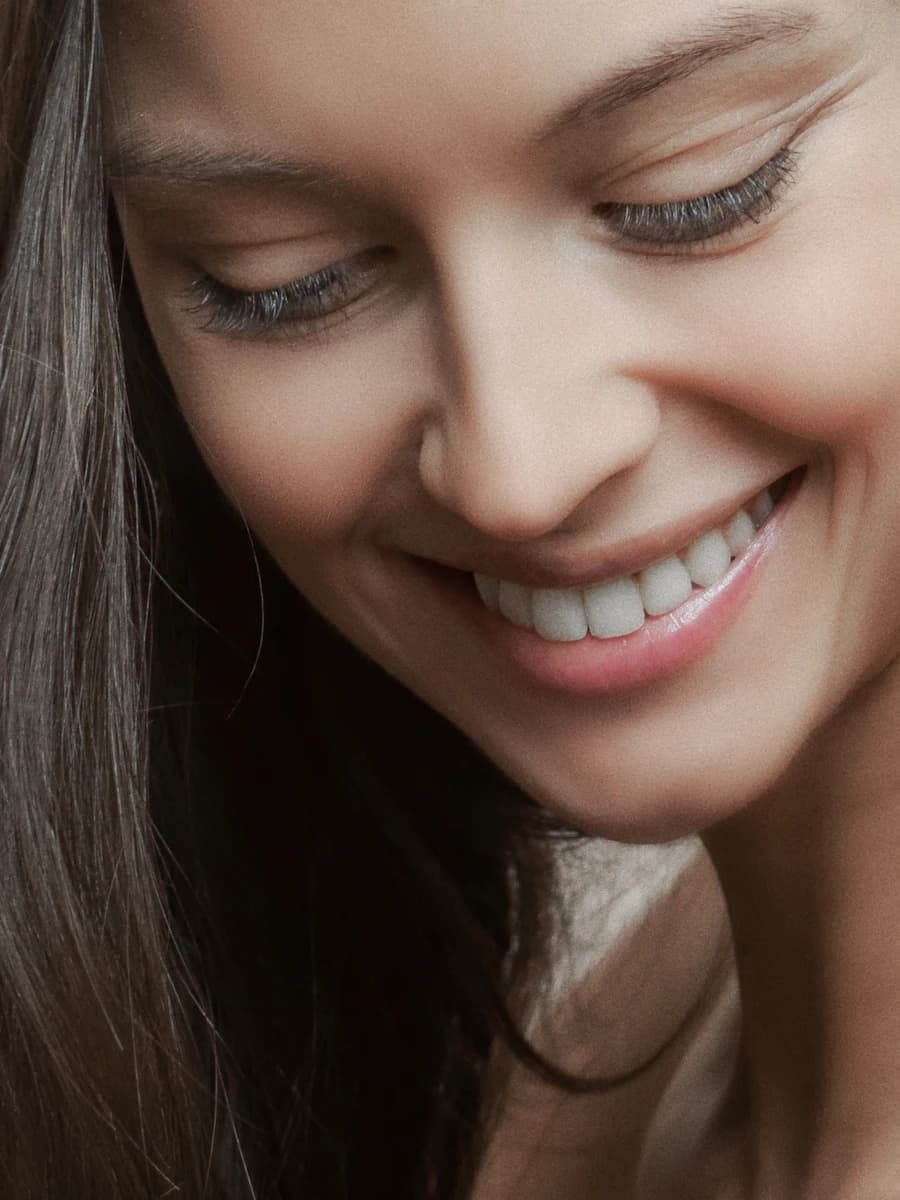 A woman smiling after a routine dental visit